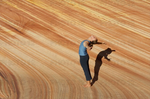 Caucasian woman practicing yoga outdoors