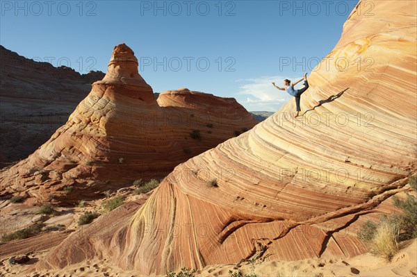 Caucasian woman practicing yoga outdoors