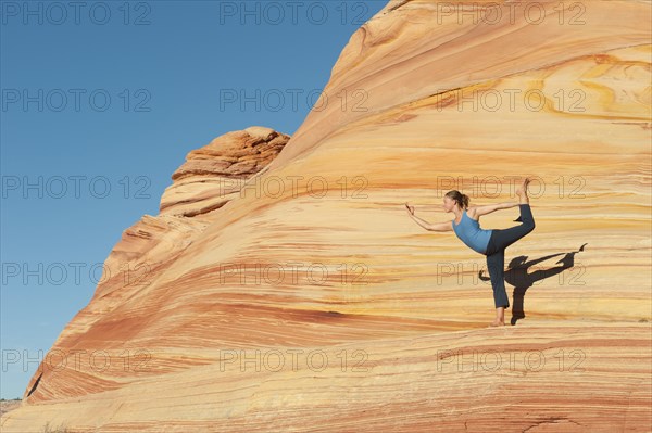 Caucasian woman practicing yoga outdoors