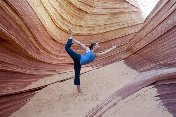 Caucasian woman practicing yoga outdoors