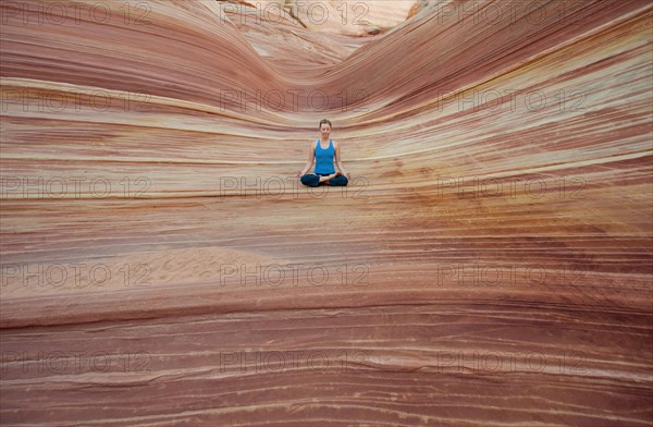 Caucasian woman practicing yoga outdoors