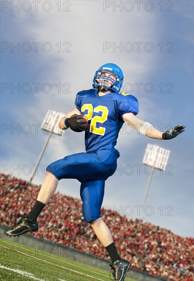 Caucasian football player running with ball