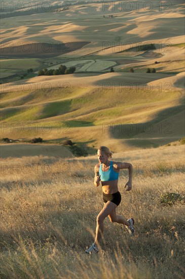 Caucasian woman running in remote area