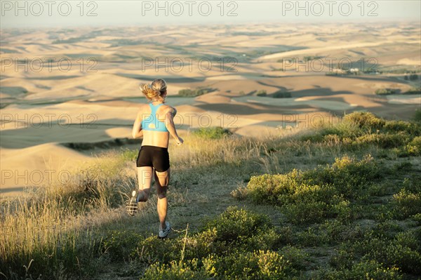 Caucasian woman running in remote area