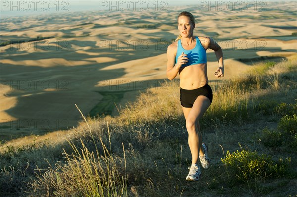 Caucasian woman running in remote area