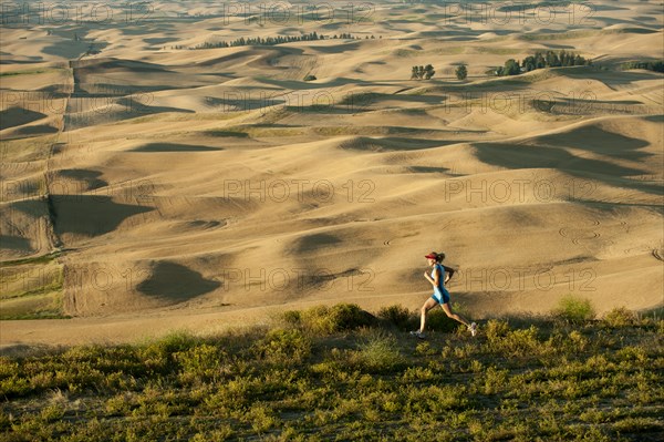 Caucasian woman running in remote area