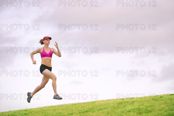 Caucasian woman running in park