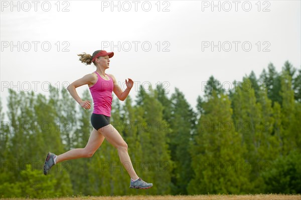 Caucasian woman running in park