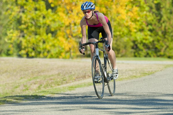 Caucasian woman riding bicycle in park