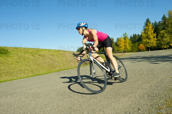 Caucasian woman riding bicycle in park