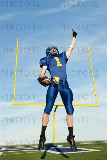 Caucasian football player cheering for victory