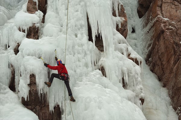 Caucasian man climbing ice