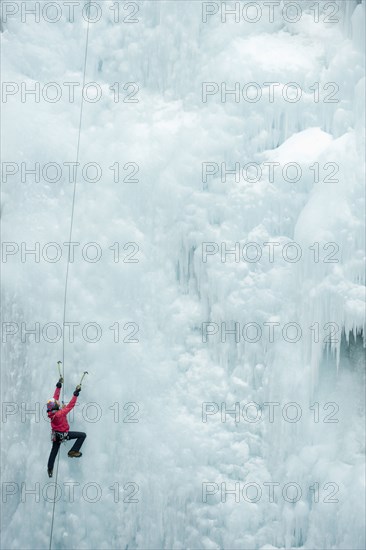 Caucasian man climbing ice