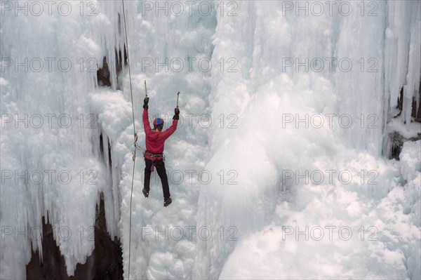 Caucasian man climbing ice