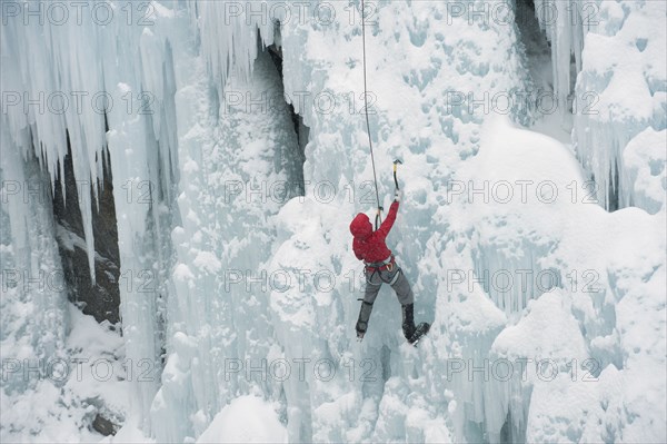 Caucasian man climbing ice