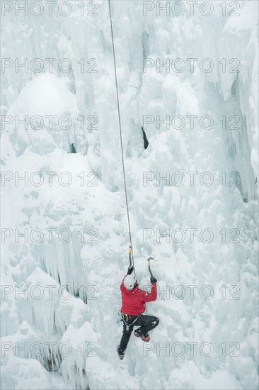 Caucasian man climbing ice