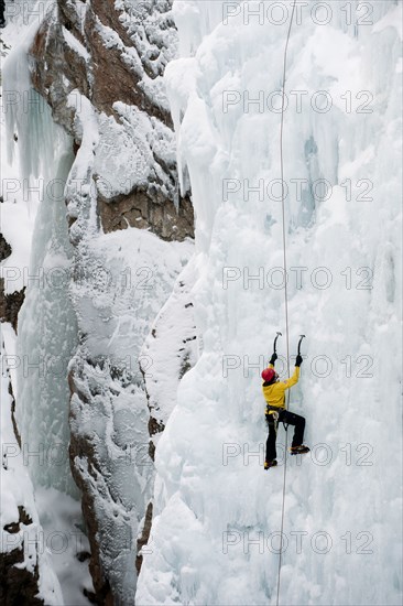 Caucasian man climbing ice