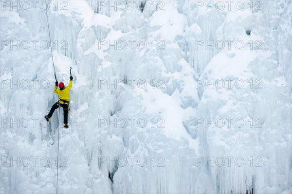 Caucasian man climbing ice