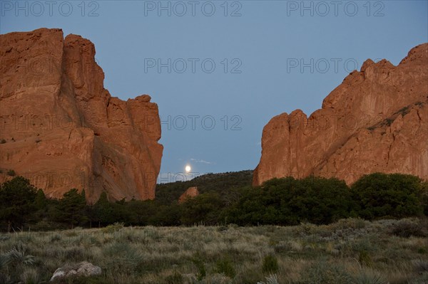 Red cliffs rising in rural landscape