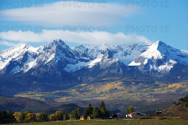 Snowy mountains overlooking rural landscape
