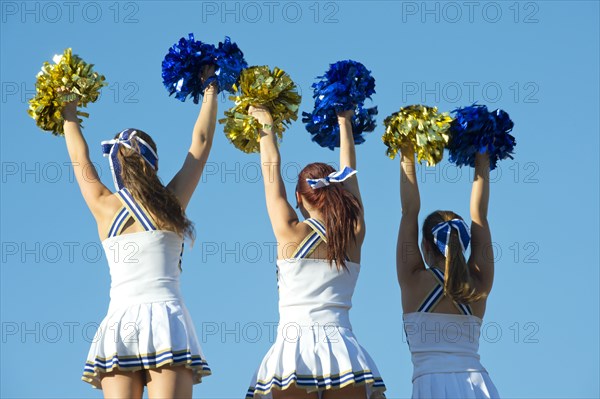 Caucasian cheerleaders practicing together