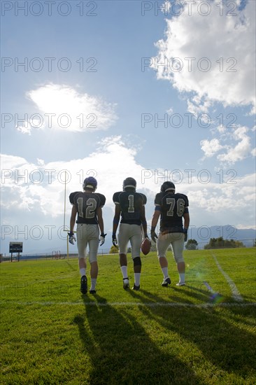 Football players walking on field