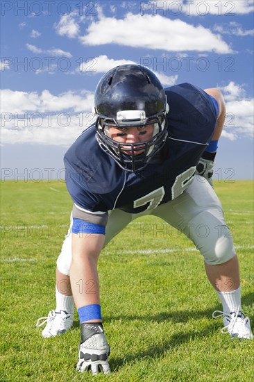 Caucasian football player poised on field