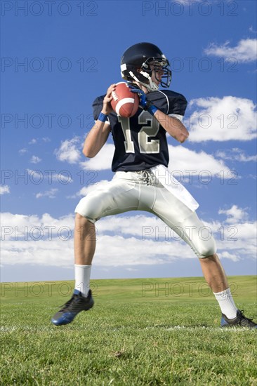 Caucasian football player poised on field