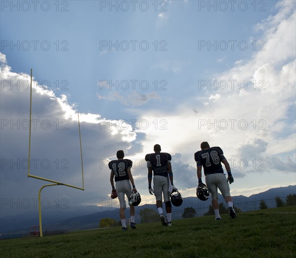 Football players walking on field