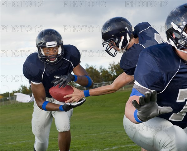 Football players passing ball