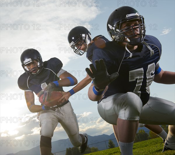 Football players passing ball