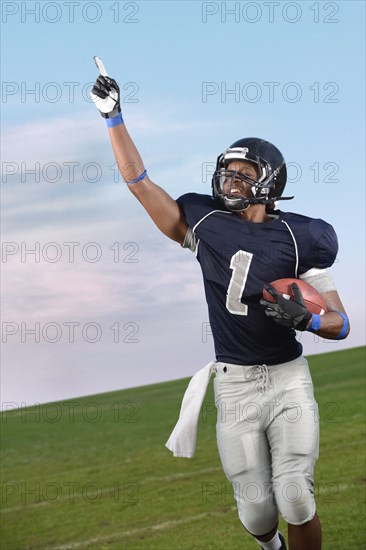 African American football player cheering in game