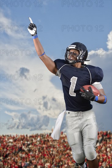 African American football player cheering in game