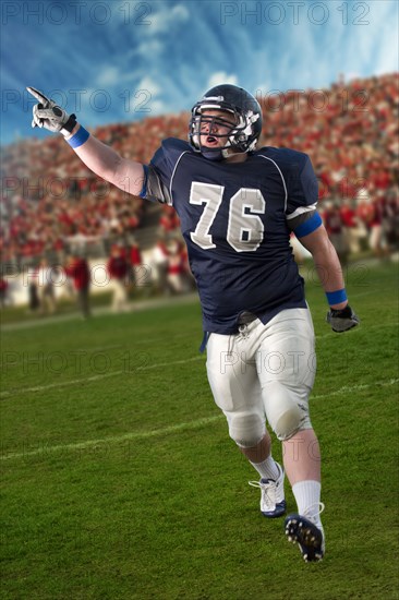 Caucasian football player cheering in game