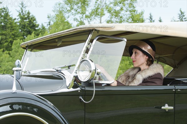 Caucasian woman driving vintage car