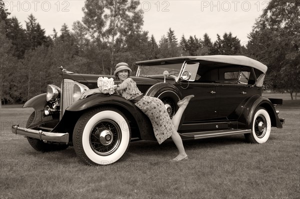 Caucasian woman on vintage car