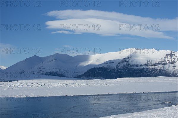 Snowy mountains overlooking arctic landscape