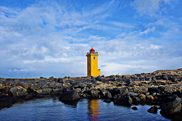 Lighthouse overlooking rocky landscape