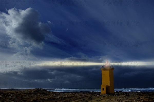 Lighthouse shining over rocky landscape