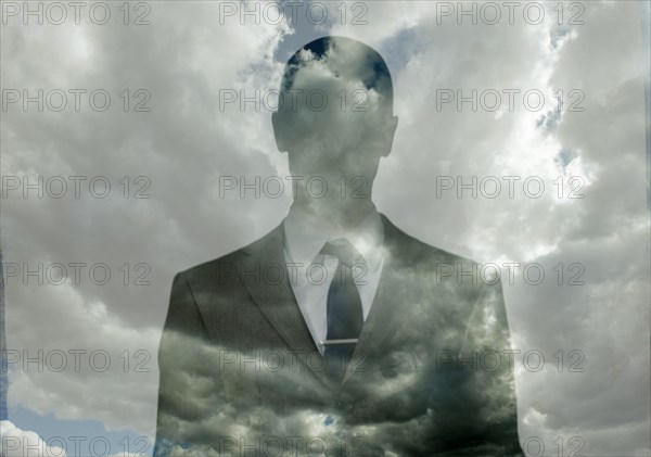 Double exposure of businessman in clouds