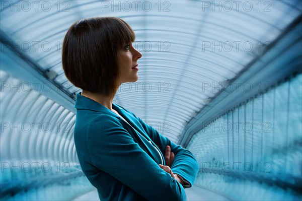 Caucasian businesswoman standing in tunnel