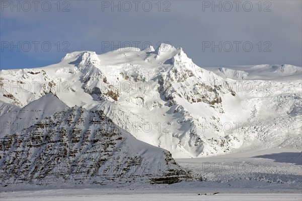 Iceberg looming over arctic landscape