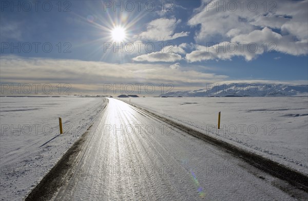 Tire trucks on rural road in snowy landscape