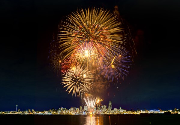 Fireworks exploding over Seattle city skyline