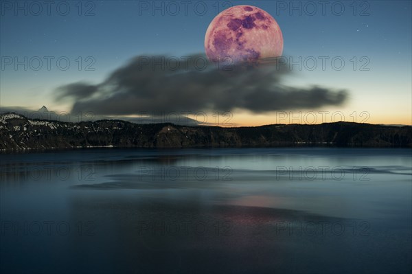 Moon over dark cloud at Crater Lake