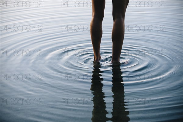 Reflection of legs of Korean woman with ripples in water