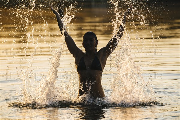 Korean woman splashing in lake