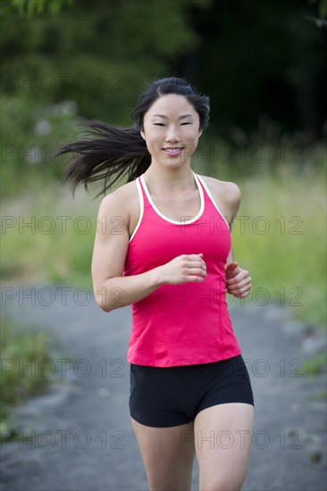 Korean woman running on remote path