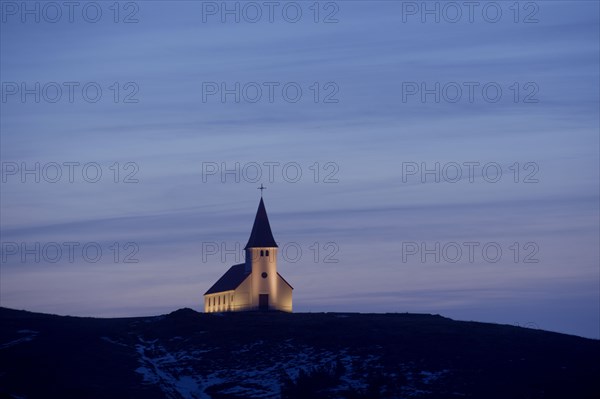 White church illuminated in remote landscape