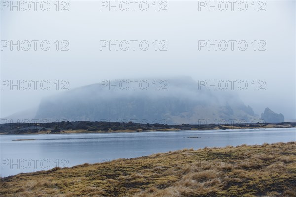 River near misty remote mountain